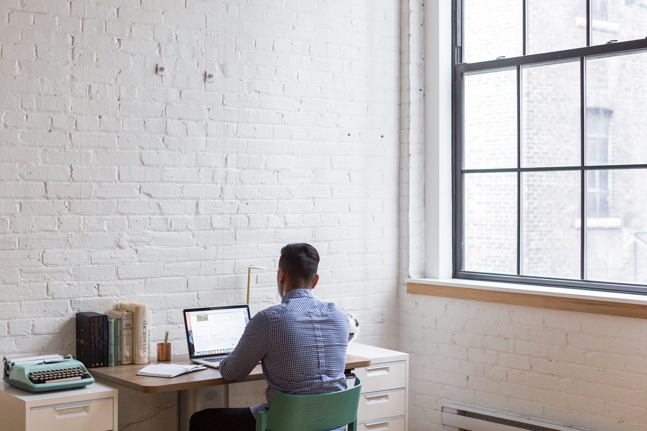 Man sitting at a desk using his laptop
